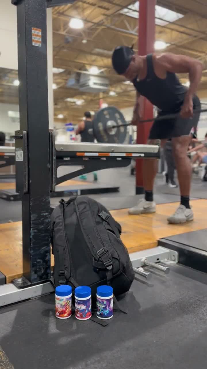 Load video: Creator holds two Creatine Adventure tubs, then trains with a barbell in a gym